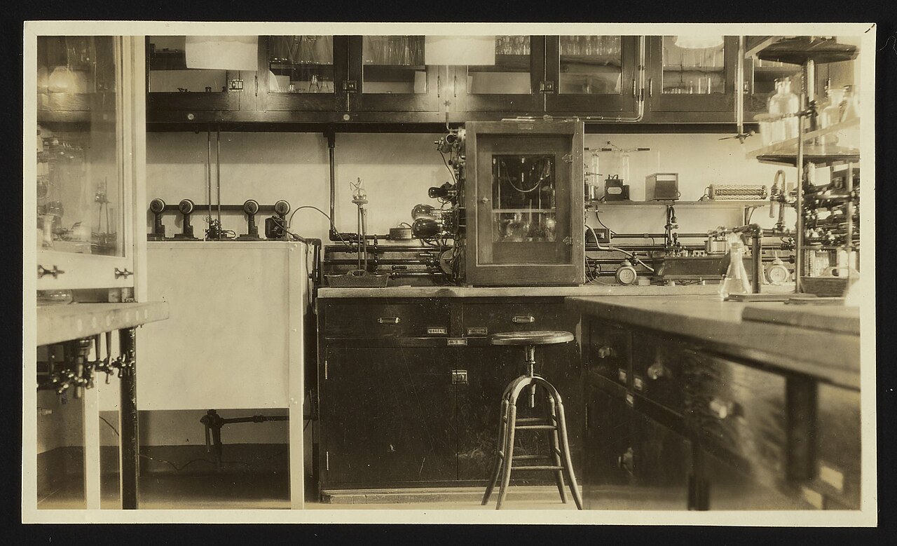 A laboratory bench with scientific equipment and record-keeping materials.