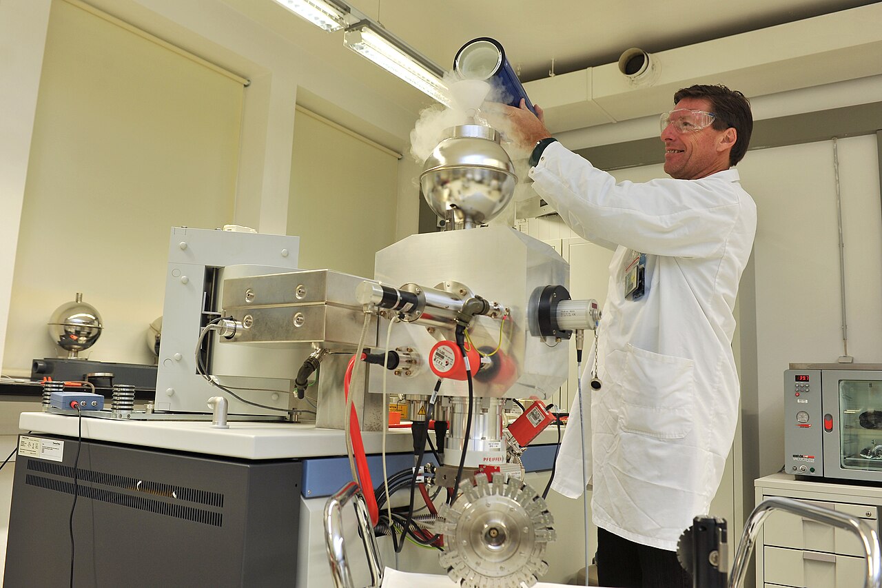 A technician working at instrumentation in a mass spectrometry laboratory.