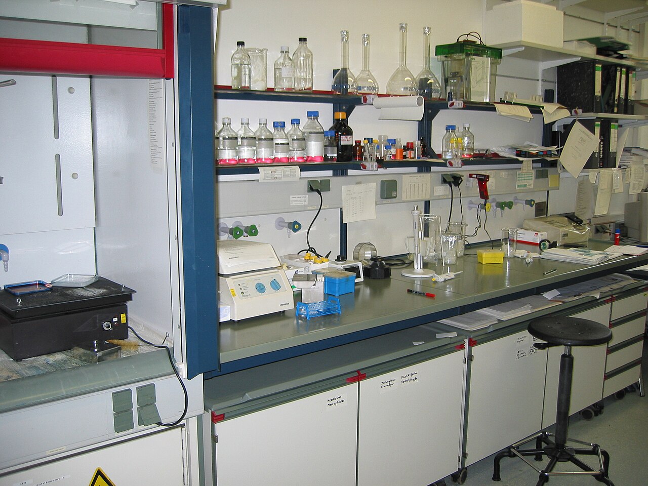 A laboratory bench lined with glassware and instruments used in biochemistry research.